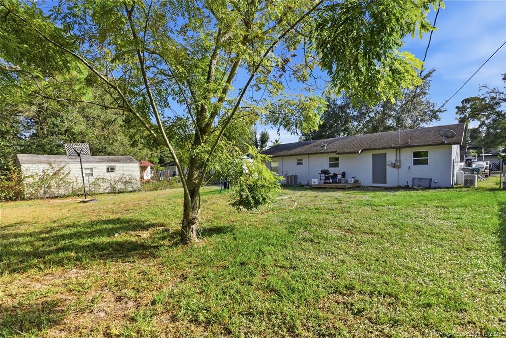 3031 Northwest 2nd Street Okeechobee, FL 34972 - Photo 18 of 19 a view of a house with a yard