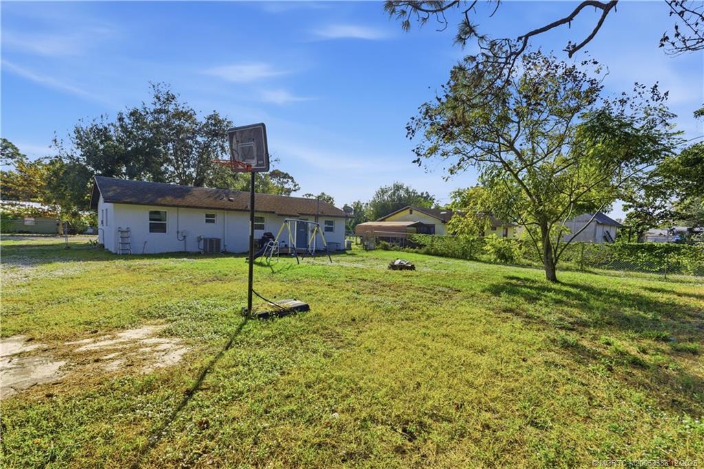 3031 Northwest 2nd Street Okeechobee, FL 34972 - Photo 19 of 19 a view of a house with a yard