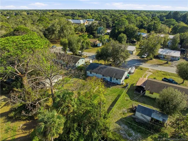 an aerial view of a house with a yard basket ball court and outdoor seating
