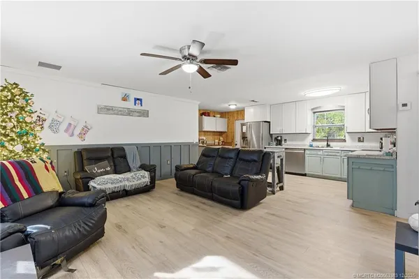 a living room with furniture and kitchen view