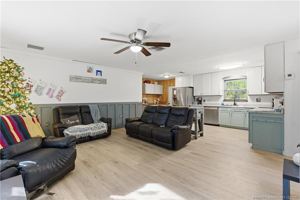 3031 Northwest 2nd Street Okeechobee, FL 34972 - Photo 8 of 19 a living room with furniture and kitchen view