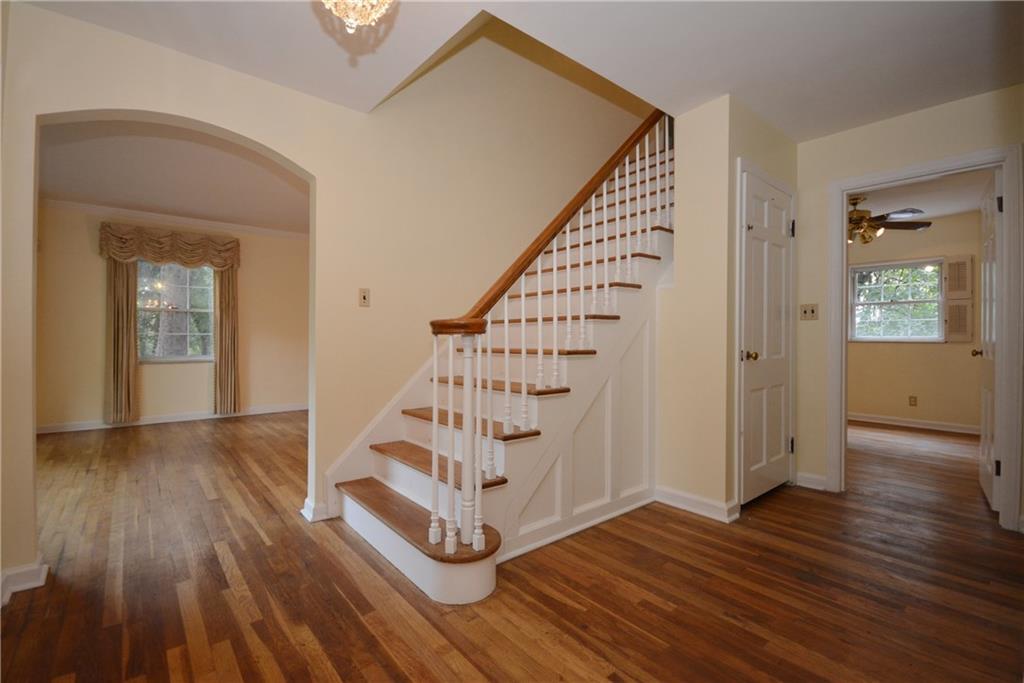 101 Colonial Drive McKees Rocks, PA 15136 - Photo 3 of 25 Entrance hall: Living room on the left, basement door on right of staircase, bedroom with ceiling fan.