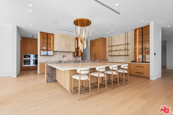 a large kitchen with a table and chairs