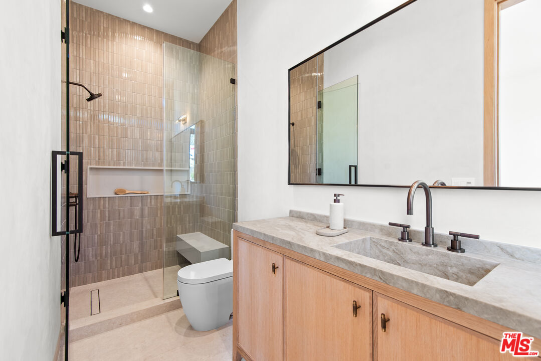 5340 Whitman Road Hidden Hills, CA 91302 - Photo 17 of 57 a bathroom with a granite countertop sink toilet and shower