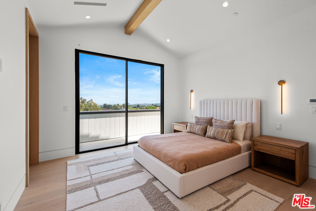 5340 Whitman Road Hidden Hills, CA 91302 - Photo 26 of 57 a bedroom with a large bed and a large window