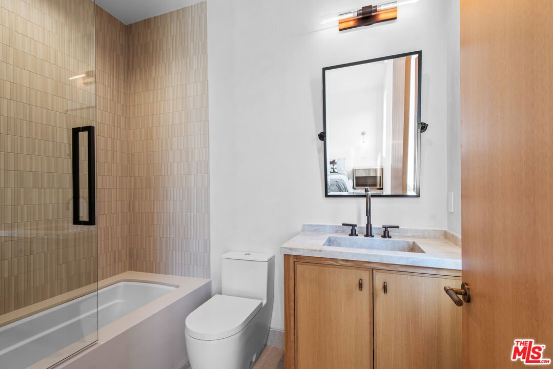 5340 Whitman Road Hidden Hills, CA 91302 - Photo 30 of 57 a bathroom with a granite countertop sink toilet and shower