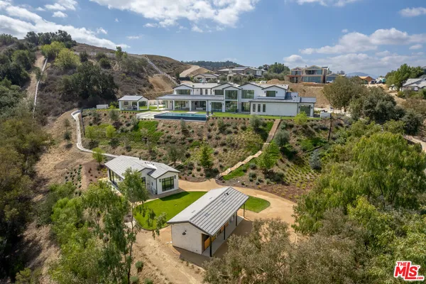 an aerial view of a house with a yard and lake view