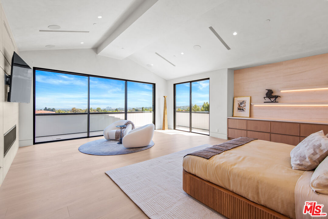 5340 Whitman Road Hidden Hills, CA 91302 - Photo 32 of 57 a bedroom with a large bed and a large window