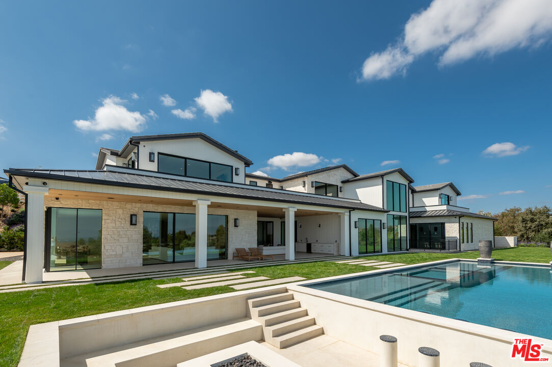 5340 Whitman Road Hidden Hills, CA 91302 - Photo 40 of 57 a view of a house with a swimming pool