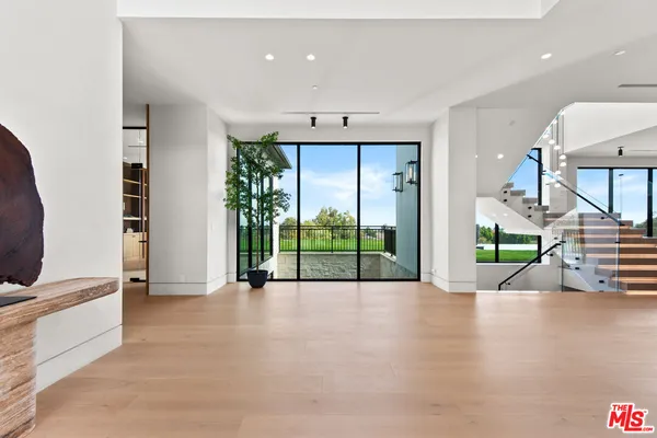 a view of an entryway with wooden floor