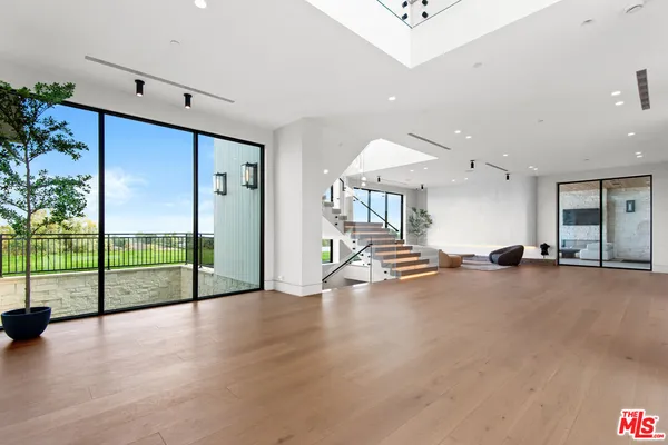 an empty room with sliding glass door and furniture