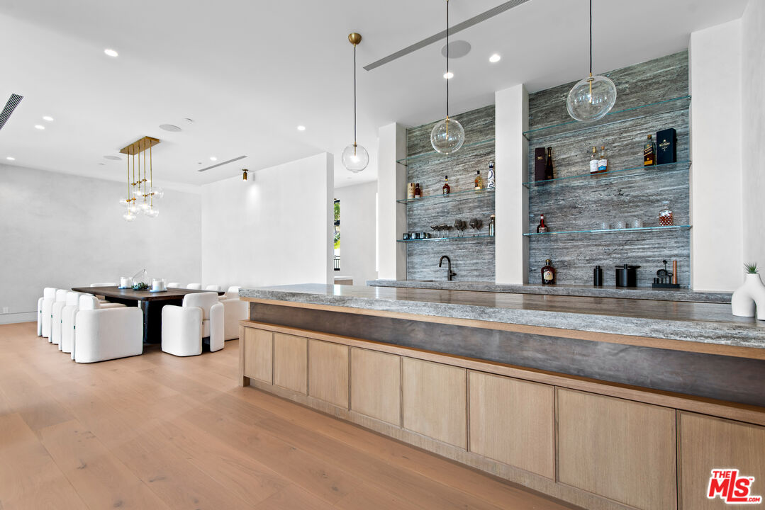 5340 Whitman Road Hidden Hills, CA 91302 - Photo 7 of 57 a large kitchen with granite countertop a sink and a refrigerator
