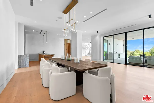 a view of a dining room with furniture wooden floor and chandelier