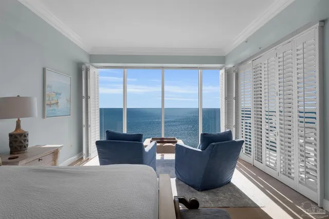 a living room with furniture and a floor to ceiling window