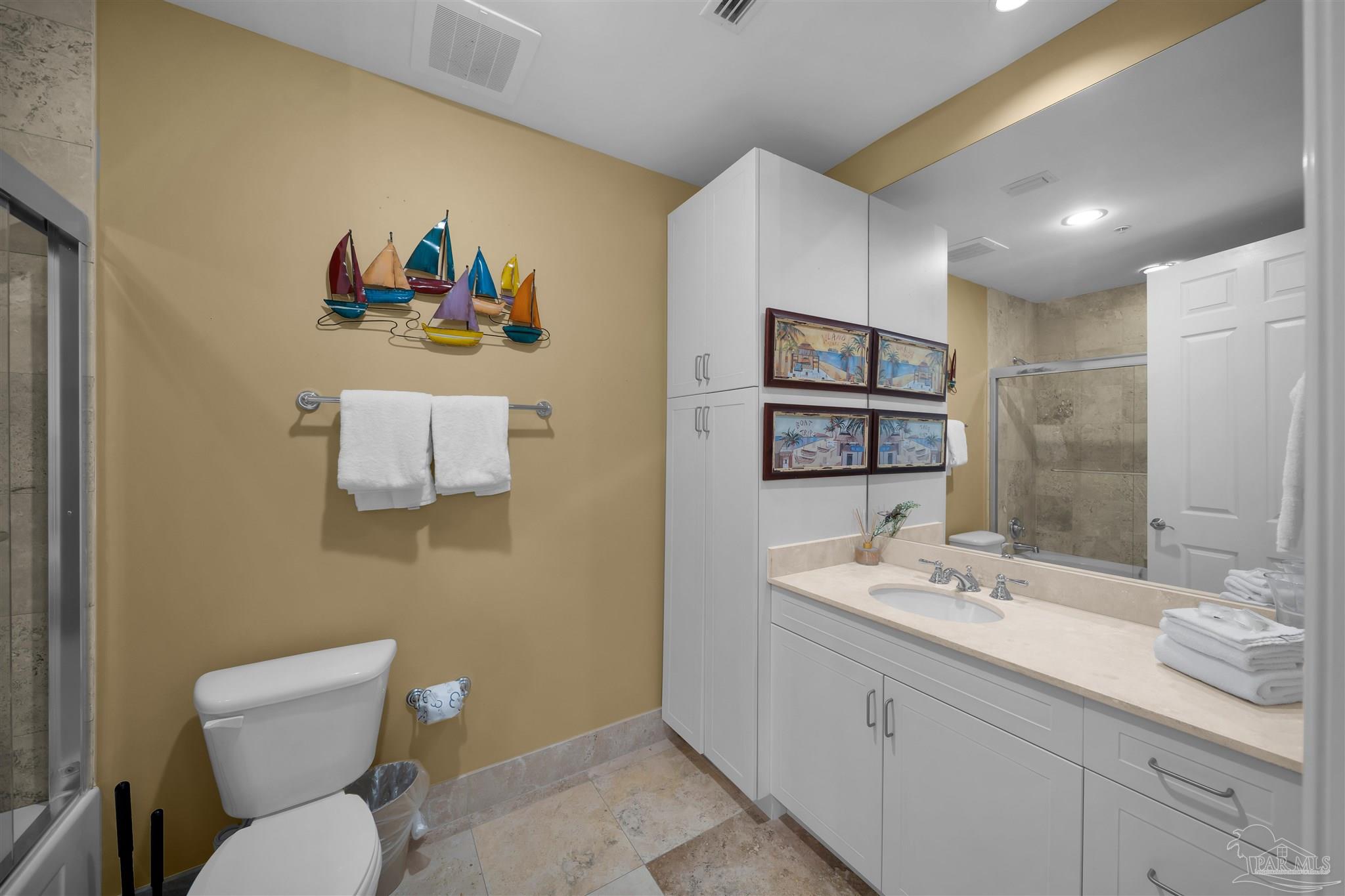 17361 Perdido Key Drive, Unit 1002W Perdido Key, FL 32507 - Photo 29 of 64 a bathroom with a toilet sink and mirror