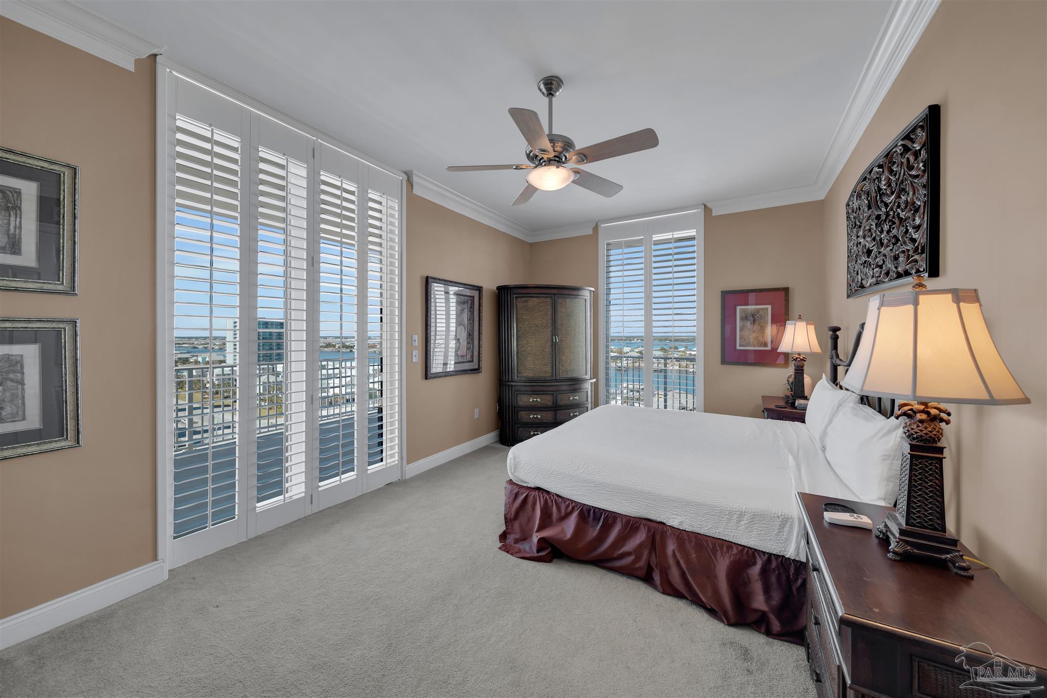 17361 Perdido Key Drive, Unit 1002W Perdido Key, FL 32507 - Photo 31 of 64 a spacious bedroom with a bed and a chandelier