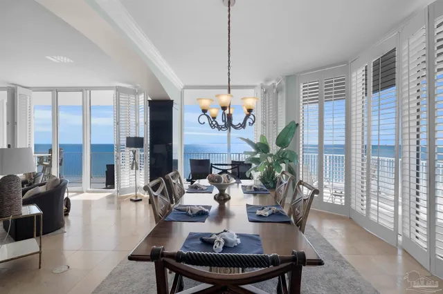 a view of a dining room with furniture large windows and wooden floor