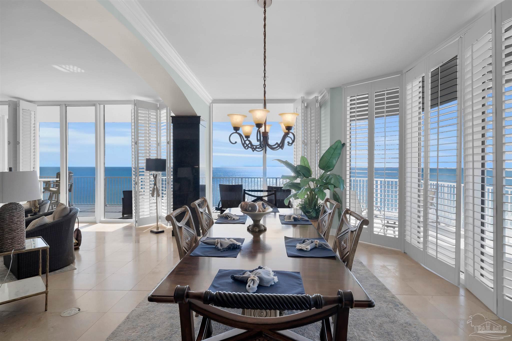 17361 Perdido Key Drive, Unit 1002W Perdido Key, FL 32507 - Photo 5 of 64 a view of a dining room with furniture large windows and wooden floor