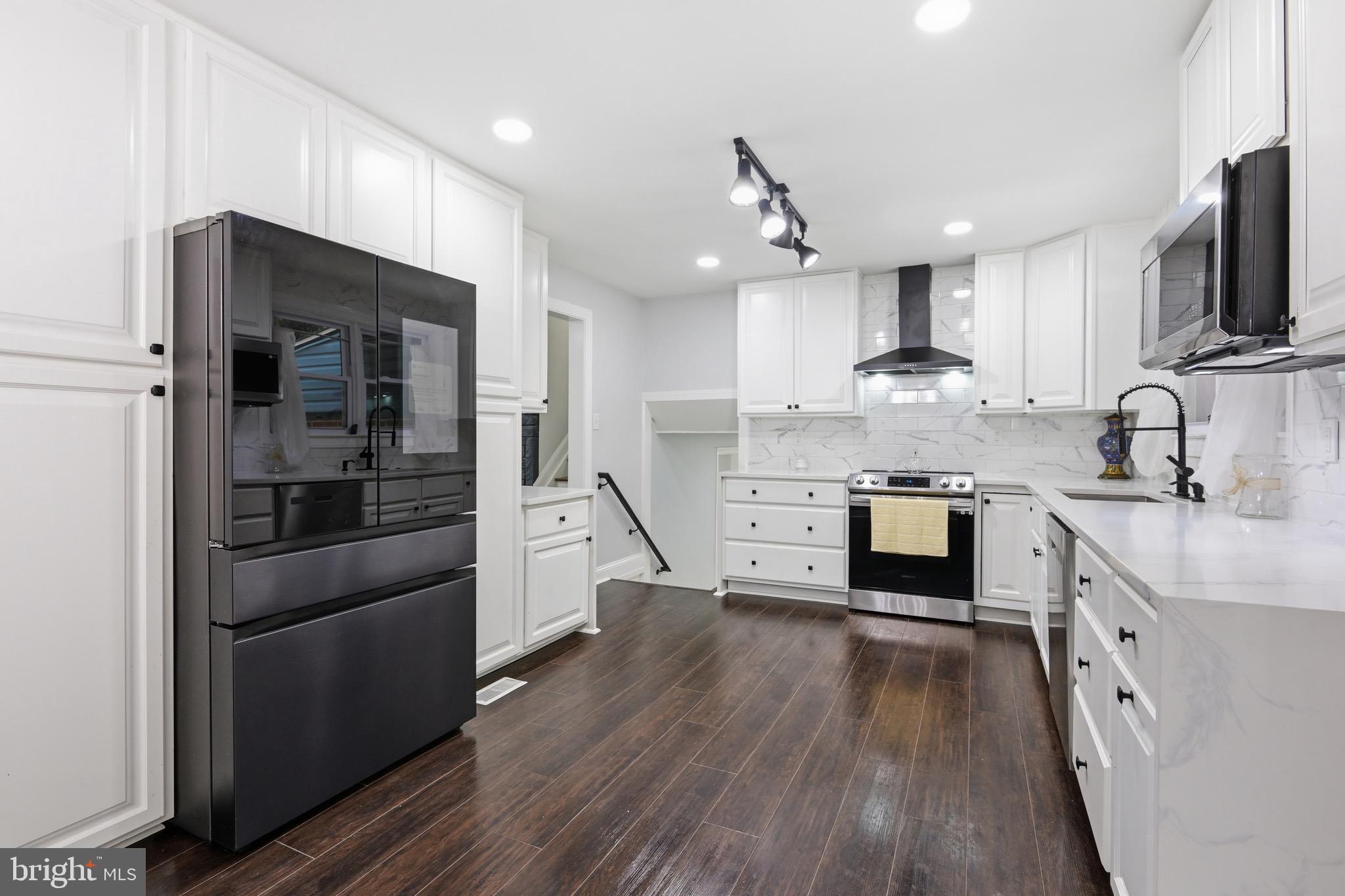 238 East Timonium Road Lutherville-Timonium, MD 21093 - Photo 15 of 40 a kitchen with stainless steel appliances a sink cabinets and wooden floor