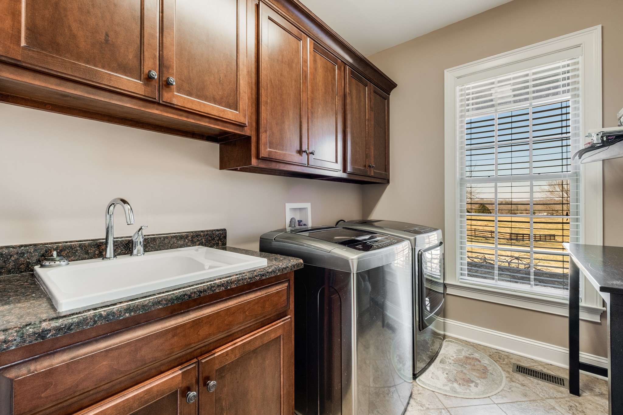 698 Dillon Road Lascassas, TN 37085 - Photo 31 of 53 a kitchen with granite countertop a sink and a stove next to a window