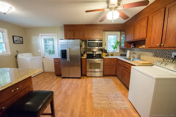 a kitchen with a sink appliances and cabinets