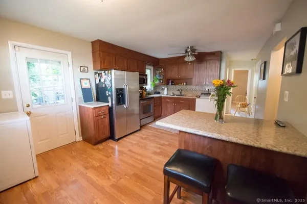 a kitchen with a table chairs refrigerator and cabinets