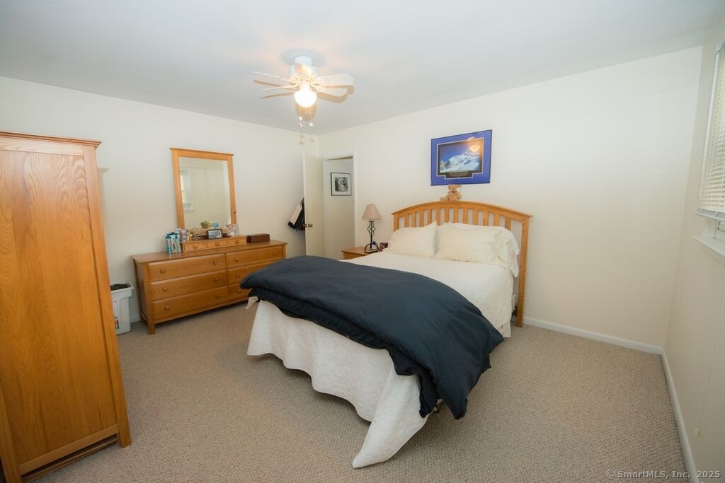 51 Waller Road Bridgeport, CT 06606 - Photo 7 of 11 a bedroom with a bed and a chandelier