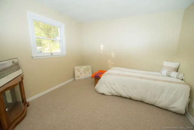 a bedroom with a bed and a tv