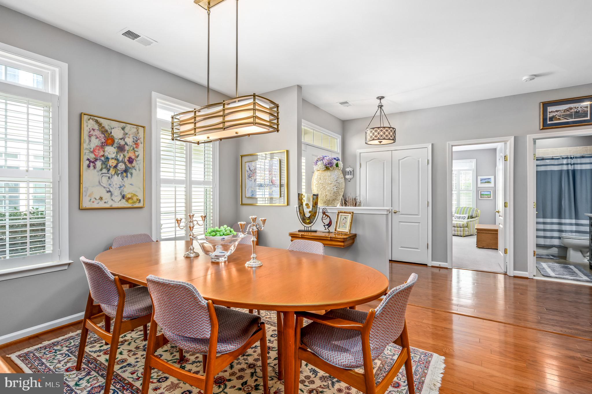 44550 Baltray Circle Ashburn, VA 20147 - Photo 11 of 44 a dining room with furniture a chandelier and wooden floor