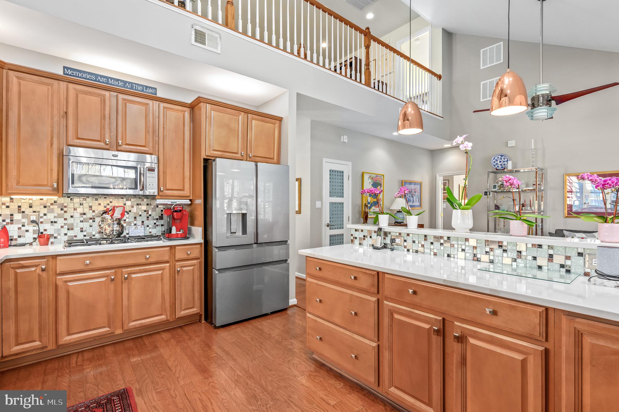 44550 Baltray Circle Ashburn, VA 20147 - Photo 20 of 44 a kitchen with stainless steel appliances kitchen island granite countertop a refrigerator and microwave