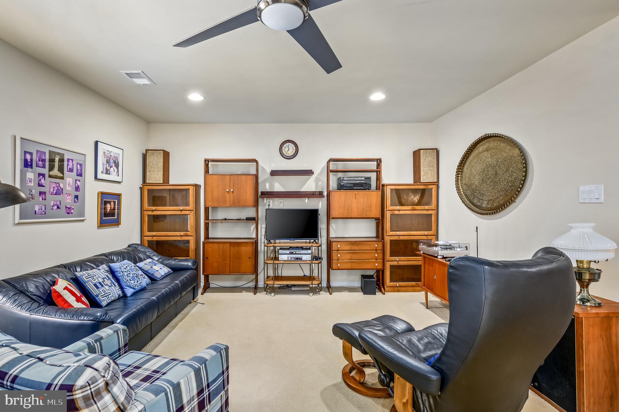 44550 Baltray Circle Ashburn, VA 20147 - Photo 38 of 44 a living room with furniture and a flat screen tv