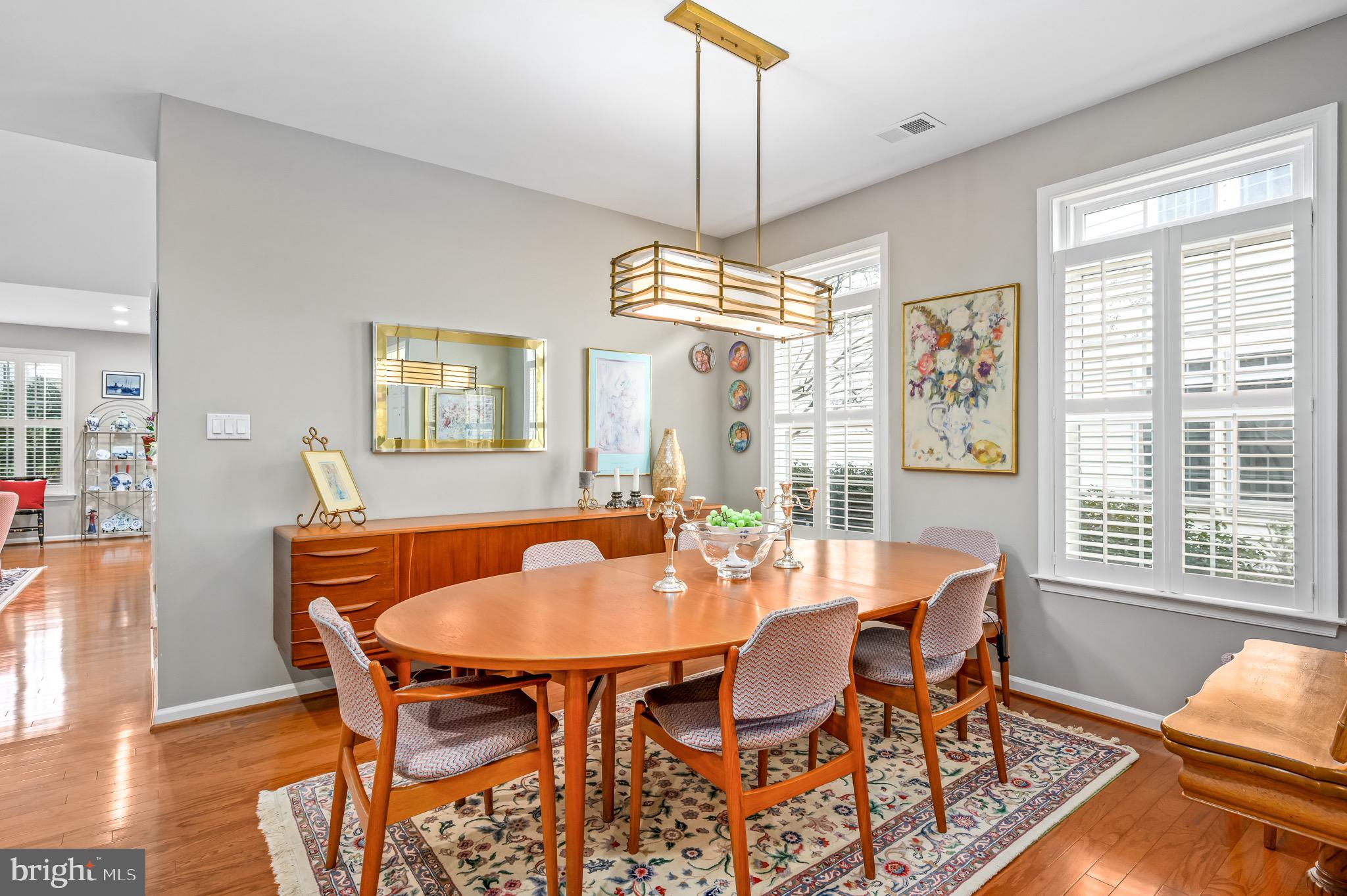 44550 Baltray Circle Ashburn, VA 20147 - Photo 10 of 44 a dining room with furniture a chandelier and wooden floor