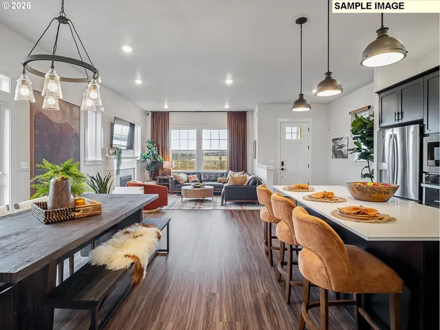 a view of a dining room and livingroom with furniture wooden floor a chandelier