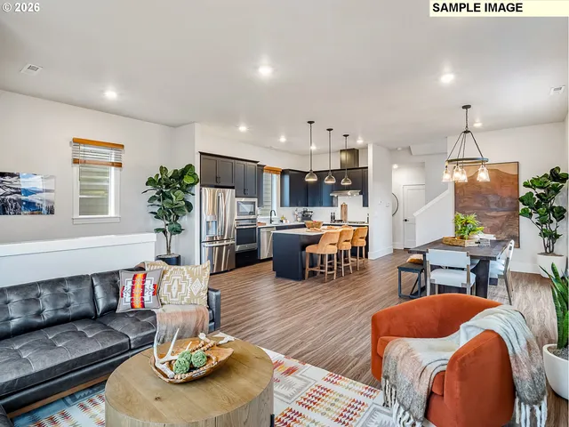 a living room with furniture kitchen and a table