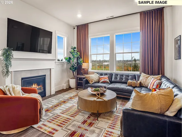 a living room with furniture fireplace and window