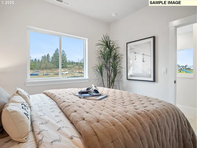 a bathroom with a granite countertop sink mirror vanity and toilet