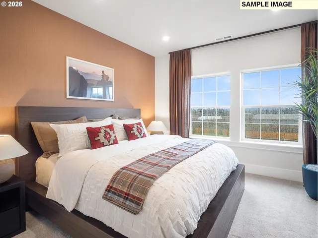 a bedroom with a large bed and a potted plant