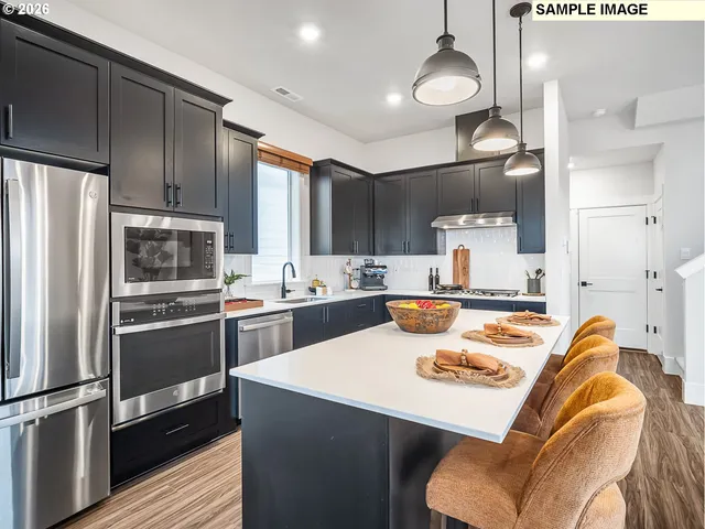 a kitchen with a sink stainless steel appliances and cabinets