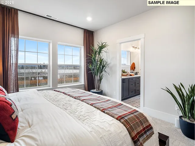 a view of walk in closet with clothes