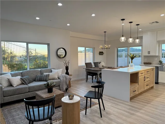 a living room with furniture a rug and a chandelier