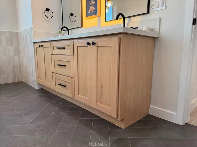 a bathroom with a sink a mirror and vanity