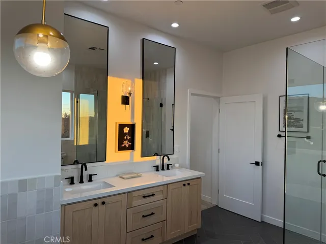 a bathroom with a sink double vanity and a mirror