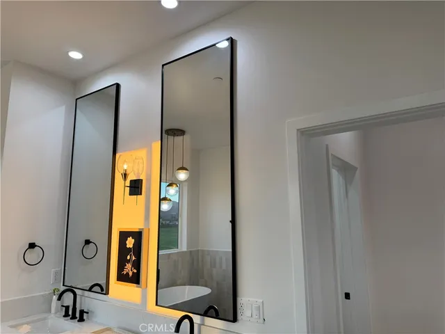 a bathroom with a mirror and a shower