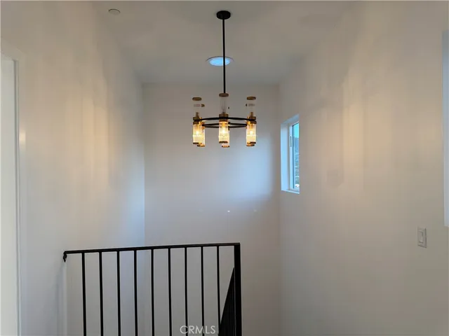 a view of a hallway with a chandelier