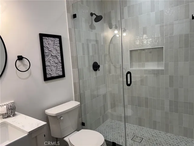 a bathroom with a toilet a sink and shower