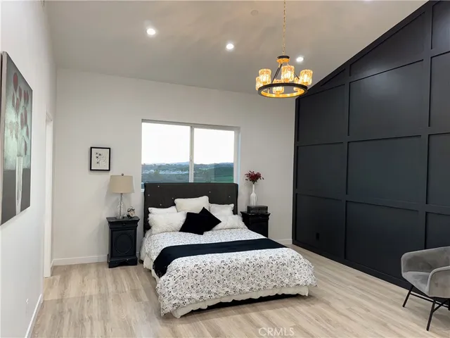 a view of a white house with a small yard and a large tree