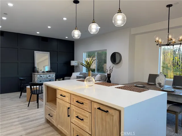 a kitchen with a table chairs and dishwasher