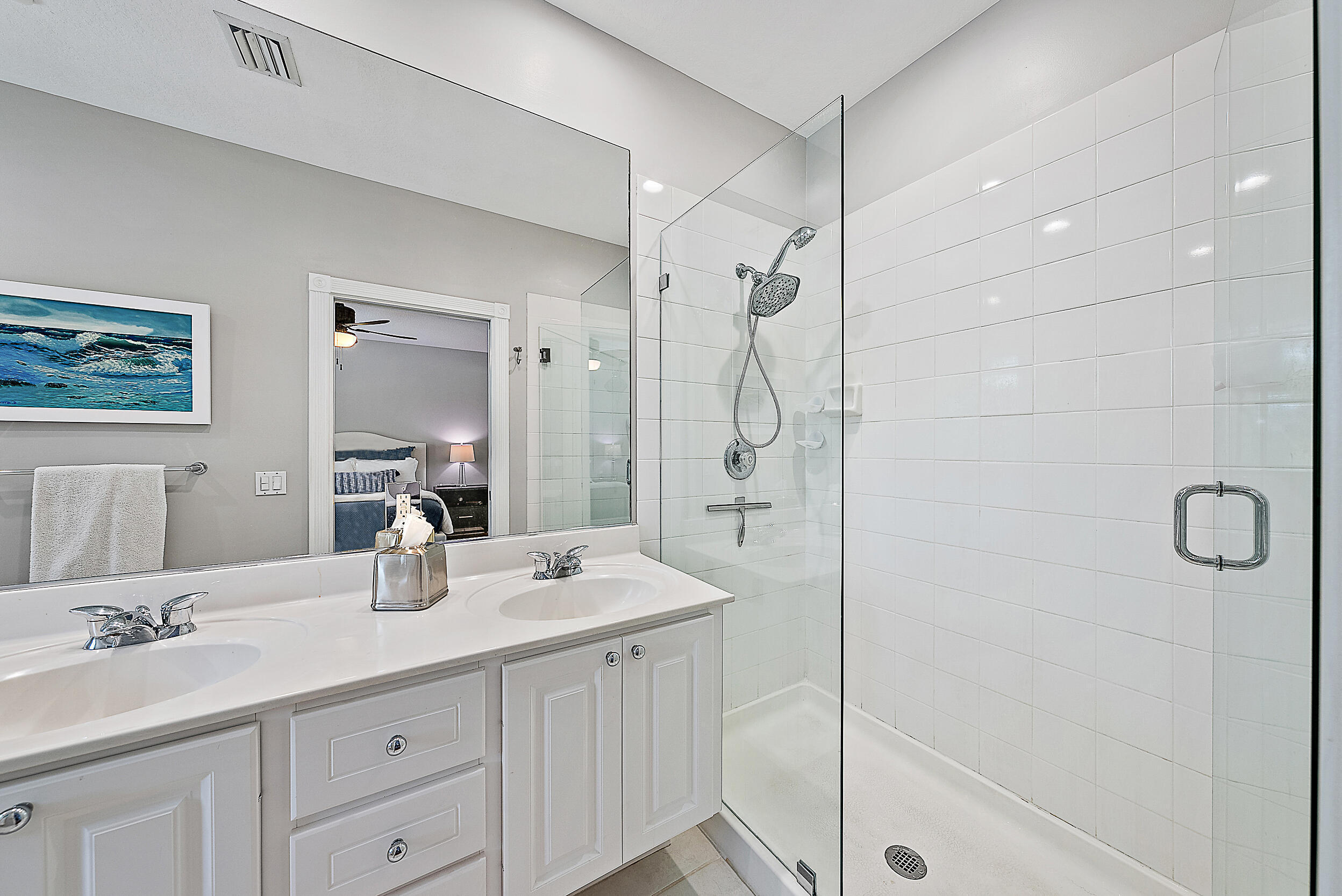 107 Rivinia Drive Jupiter, FL 33458 - Photo 8 of 28 a bathroom with a double vanity sink mirror and shower