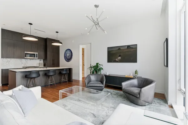 a kitchen with a table chairs and wooden floor