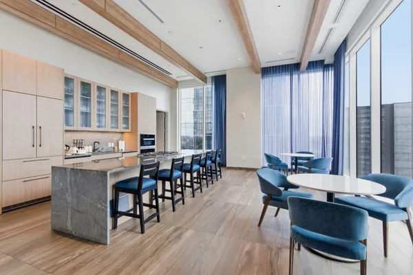a view of a balcony with chairs and wooden floor